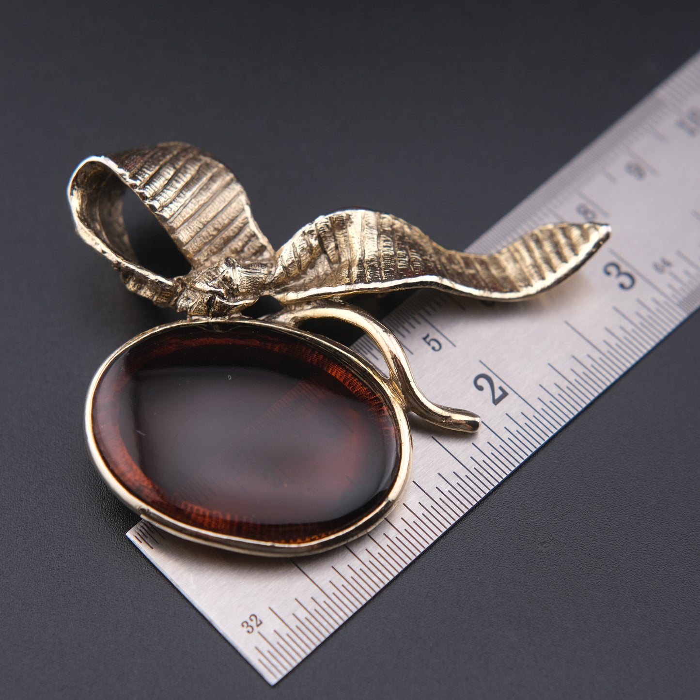 Vintage Gold-Tone Ribbon Brooch with Large Amber-Brown Glass Cabochon