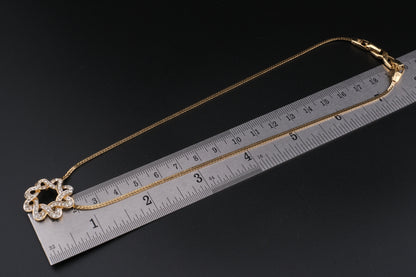 Nina Ricci Star Knot Crystal Necklace – Gold-Tone Choker Style
