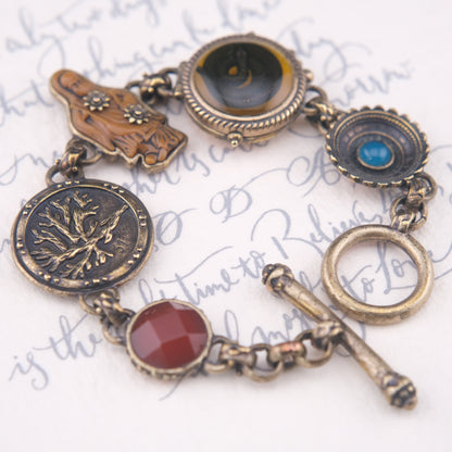 Vintage Multi-Charm Bracelet with Religious and Symbolic Motifs – Snake Locket