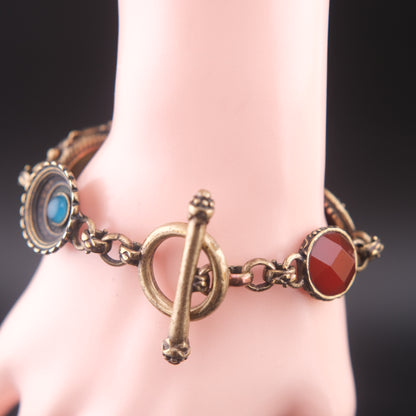 Vintage Multi-Charm Bracelet with Religious and Symbolic Motifs – Snake Locket