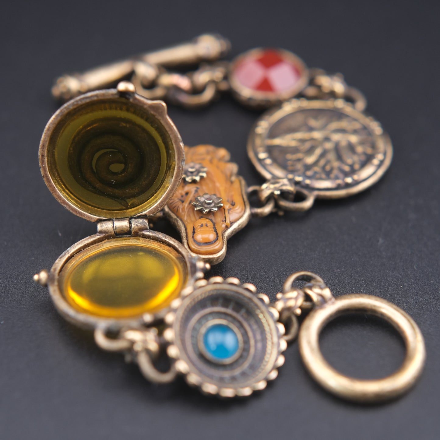 Vintage Multi-Charm Bracelet with Religious and Symbolic Motifs – Snake Locket