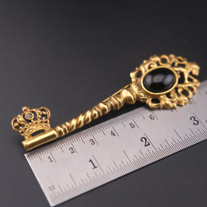 Vintage Gold-Tone Key Brooch with Black Cabochon and Crown Detail