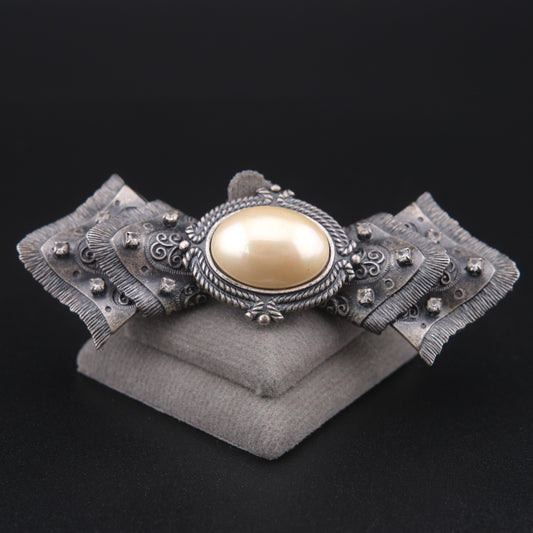 Vintage Sculptural Bow Brooch in Oxidized Silver Tone with Oval Ivory Cabochon and Rhinestone Accents, Signed