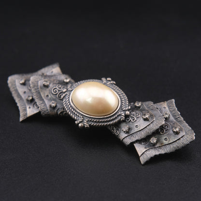 Vintage Sculptural Bow Brooch in Oxidized Silver Tone with Oval Ivory Cabochon and Rhinestone Accents, Signed