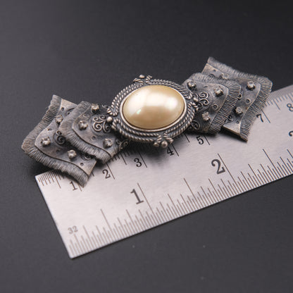 Vintage Sculptural Bow Brooch in Oxidized Silver Tone with Oval Ivory Cabochon and Rhinestone Accents, Signed