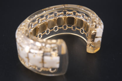 Clear Resin Cuff Bracelet with Gold-Tone Chain and White Inlay – Bold Sculptural Statement