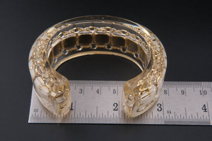 Clear Resin Cuff Bracelet with Gold-Tone Chain and White Inlay – Bold Sculptural Statement