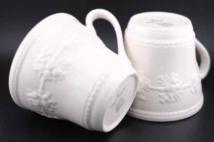 Wedgwood Festivity Raspberry Queen’s Ware Mug Pair – White Embossed Relief with Raspberry Interior Motif