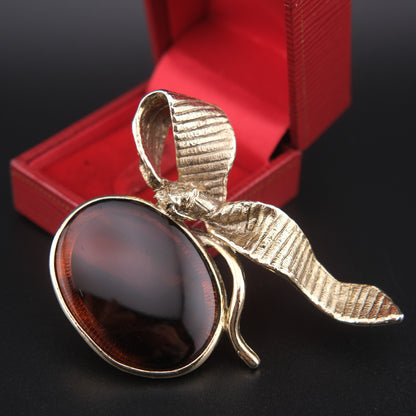 Vintage Gold-Tone Ribbon Brooch with Large Amber-Brown Glass Cabochon