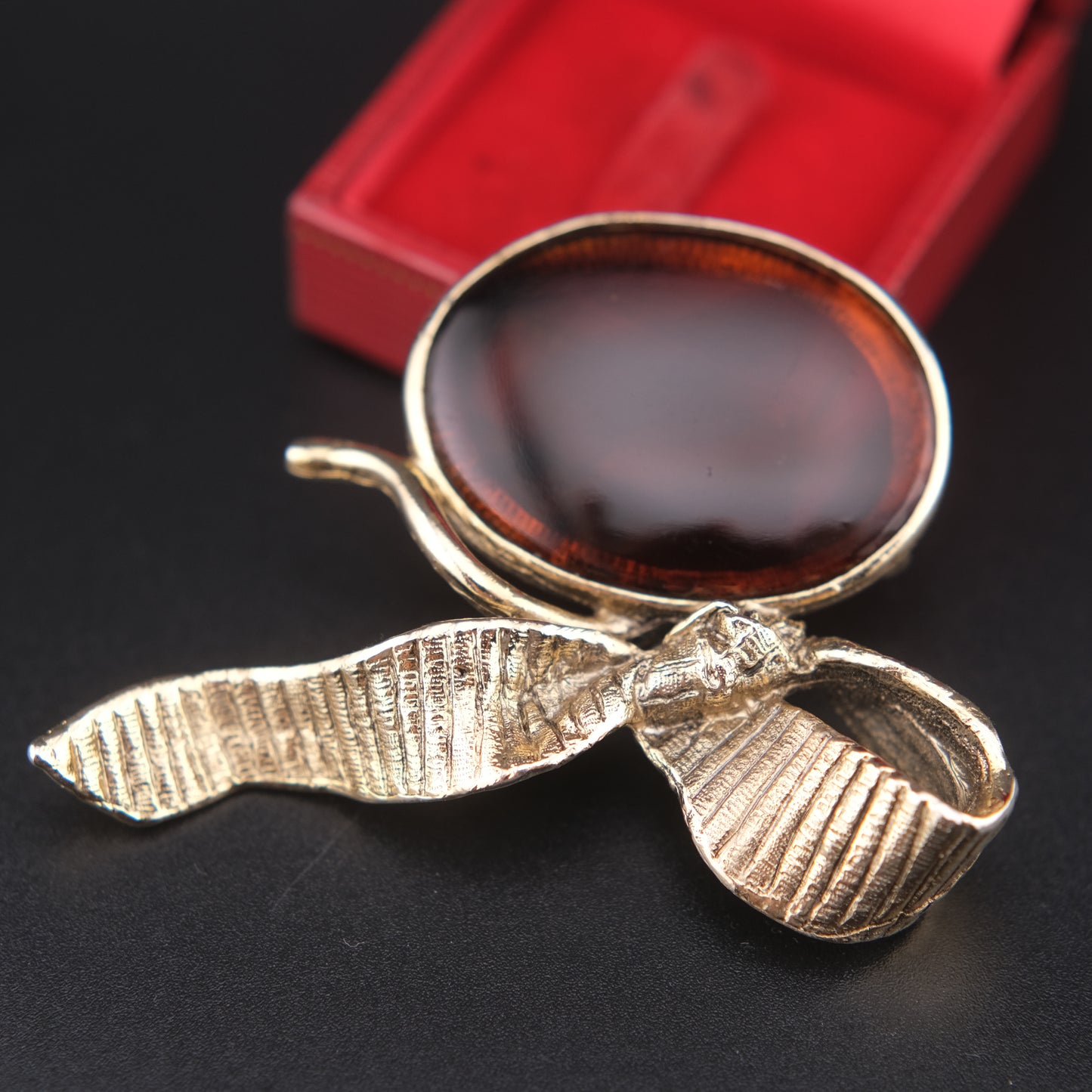 Vintage Gold-Tone Ribbon Brooch with Large Amber-Brown Glass Cabochon