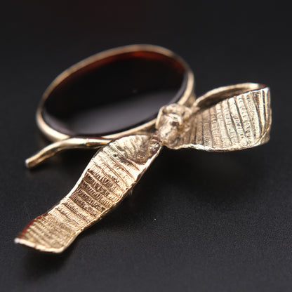 Vintage Gold-Tone Ribbon Brooch with Large Amber-Brown Glass Cabochon