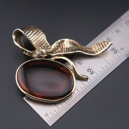 Vintage Gold-Tone Ribbon Brooch with Large Amber-Brown Glass Cabochon