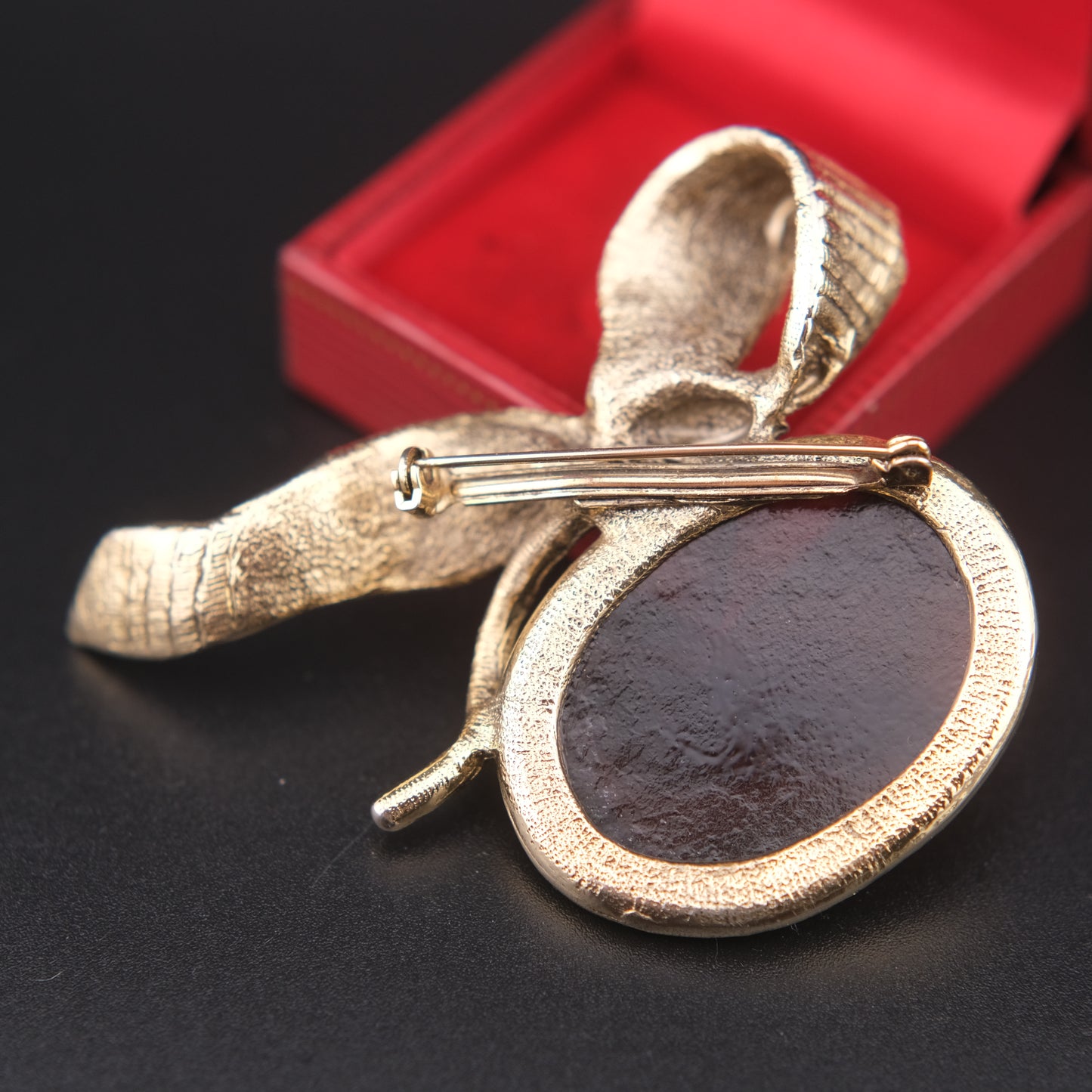 Vintage Gold-Tone Ribbon Brooch with Large Amber-Brown Glass Cabochon