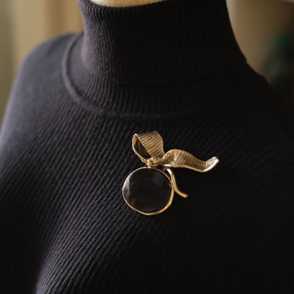 Vintage Gold-Tone Ribbon Brooch with Large Amber-Brown Glass Cabochon